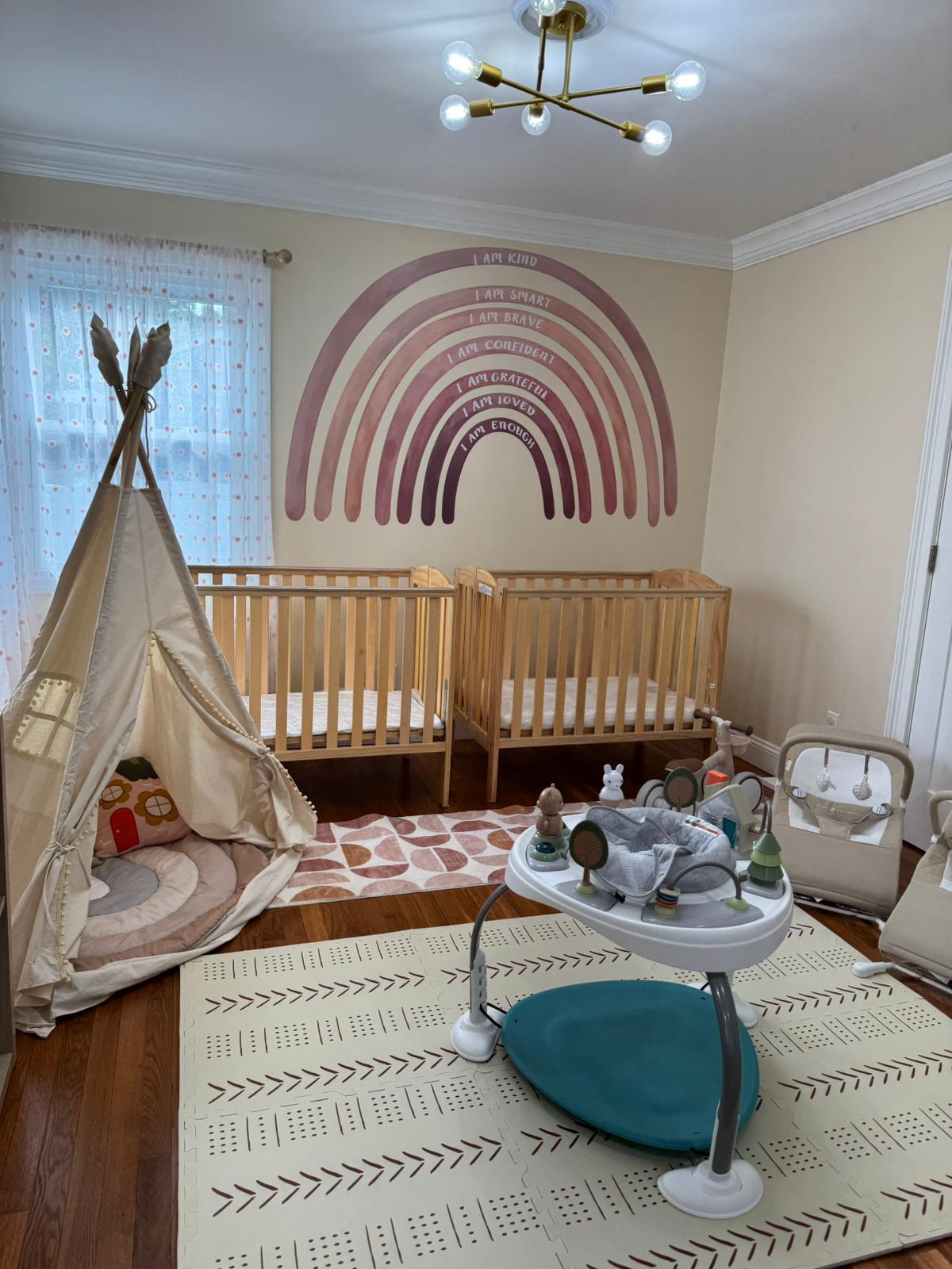 Infant room with cribs and affirmation rainbow mural