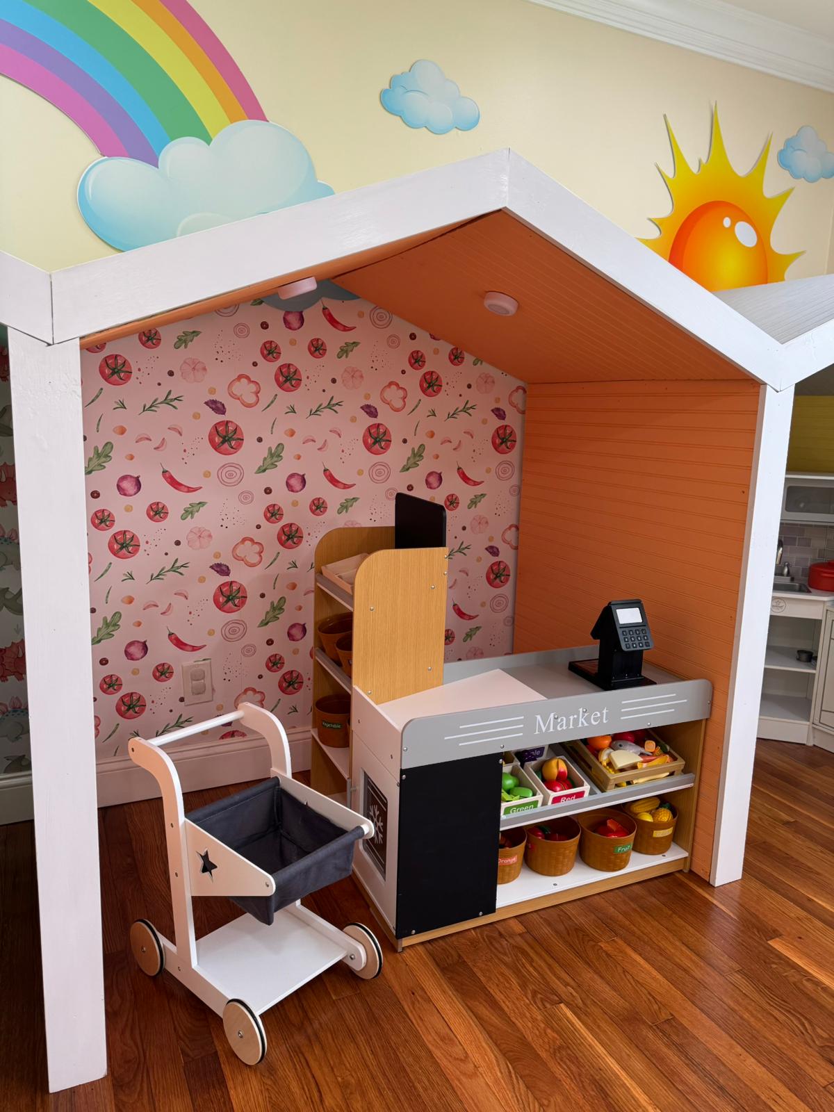 Play market area with rainbow and sun mural